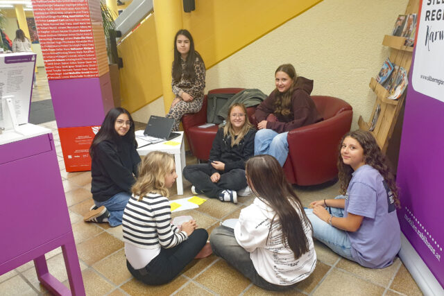 Schülerinnen arbeiten in Gruppen an den Themen